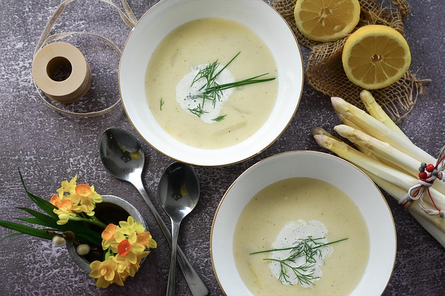 bowl of creamy potato leek soup garnished with chives alongside rustic soda bread on linen napkin