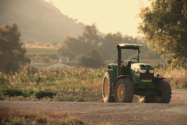 Ciaran McCarthy young farmhand working with tractor in Irish potato field